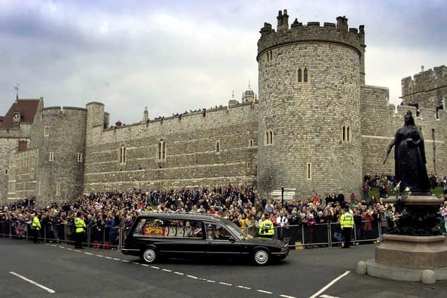 The Queen Mother’s funeral cortege passes the Queen Victoria memorial statue outside Windsor Castle on April 9 2002. Royal dignitaries and politicians from around the world gathered in London to pay their last respects to  the Queen Mother  who died March 30, aged 101. 