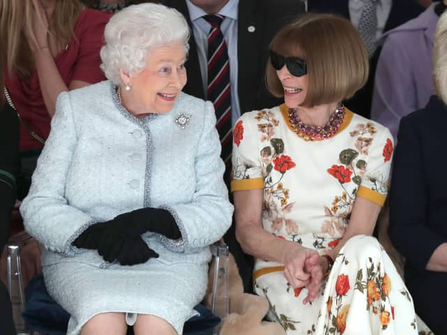 LONDON, ENGLAND - FEBRUARY 20:  Queen Elizabeth II sits next to Anna Wintour as they view Richard Quinn’s runway show before presenting him with the inaugural Queen Elizabeth II Award for British Design as she visits London Fashion Week’s BFC Show Space on February 20, 2018 in London, United Kingdom. (Photo by Yui Mok - Pool/Getty Images)