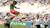 Forward Francois Omam-Biyick from Cameroon scores with a header as Argentinian defenders Nestor Lorenzo (L) and Juan Simon look on during the opening match of Italia 90  (STAFF/AFP via Getty Images)