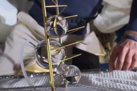 Liat Segal & Dr. Yasmine Meroz's artwork being unveiled on the ISS where microgravity allows the water to stick to the metal frame in large globules