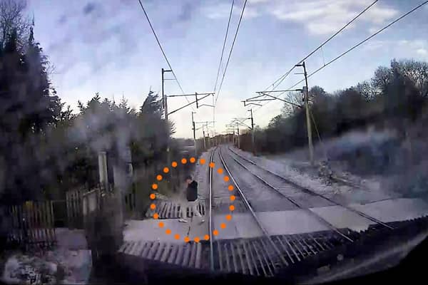 The video shows a man just inches from being hit by the speeding train.