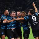 Lee Mack celebrates his goal with World XI teammates including Steven Bartlett (left-centre)