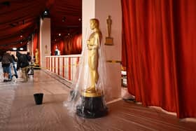 A bucket collects water leaking from the ceiling as rain from a winter storm falls on the not so red carpet arrivals area, ahead of the 95th Academy Awards, in Hollywood, California, on March 10, 2023.