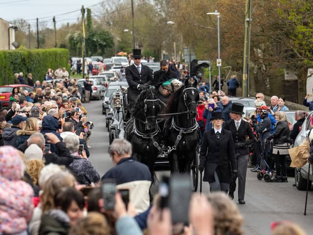 The funeral cortege for Paul O'Grady passes through the village of Aldington 