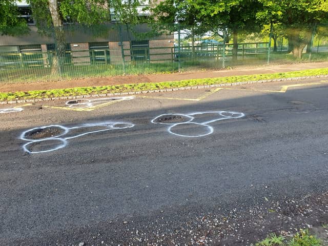 Locals appear to have lost patience waiting for the holey highway in East Sussex to be repaired - and the resulting crude phallus drawings have attracted interest online. 