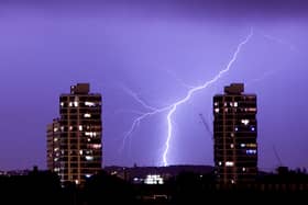 Lightning flashes in the night sky over south London. A weather warning is in place for thunderstorms today (Sunday, June 18) across England, Wales and Northern Ireland.