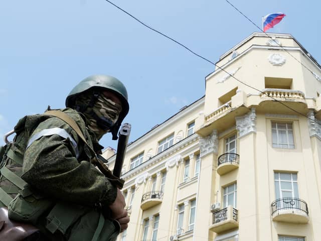 A member of Wagner group stands guard in a street in the city of Rostov-on-Don