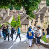 Tourists in Castle Combe, Wiltshire.