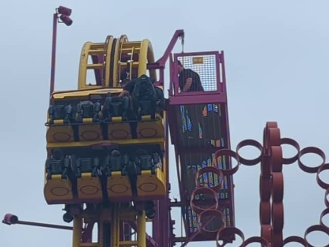 Horrified onlookers watched as rescuers scrambled to the aid of eight terrified people stuck “at the top” of a 22-metre rollercoaster.
