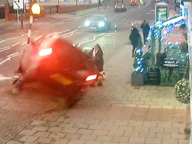 CCTV capturing the dramatic moment a mum managed to pull her two-year-old daughter to safety seconds before her pram was crushed underneath a car in a heart-stopping crash (SWNS)
