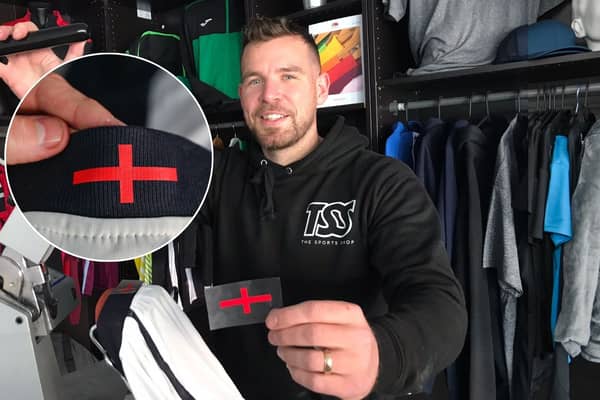 Director Grant Walters at The Sports Shop in Kingswinford show off their St George's Cross transfer to apply to new England kit. A sports shop is selling St George’s Cross iron-on transfers for £4.95 - so fans can cover the controversial design on the new England football shirt. 