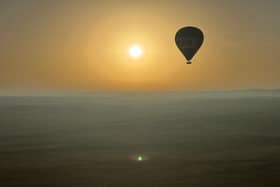Journalist Nicola Adam journeys across the Dubai desert at dawn by hot air balloon

