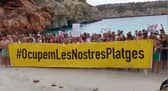 Majorca anti-mass tourism protesters ‘occupy’ beach.