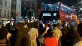 Excited England fans dance around “Bellingham” bus.