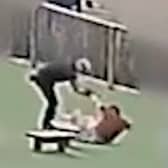 Still from footage of William Kevin Clifford subjecting 11-year-old Tobie Orlowski to a sustained attack in which he pushed the schoolboy to the ground multiple times in the grounds of Tettenhall Wood School in Wolverhampton. 