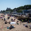 Members of the public relax on the beach in hot weather in Cleethorpes, north east England.