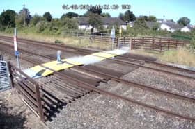 Toddler steps onto Sandy Lane level crossing in Prestatyn, North Wales.
