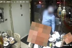 Man allegedly distracts diners before ‘swiping phone’.