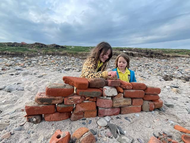 Heidi and Thea on the beach on Holy Island. Meet the family who live on an island that can only be accessed twice a day and only has five children in the local school. 