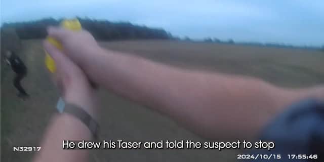 PC Haddon Smith draws his taser.
