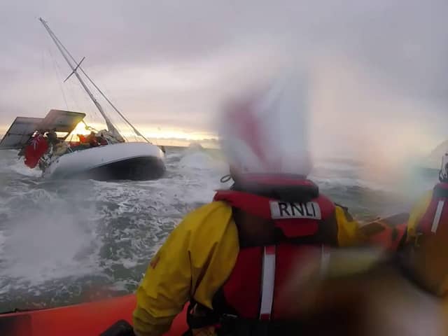 Dramatic footage shows the terrifying moment huge waves crashed into a yacht- seconds before rescue. 