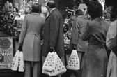 Shoppers pictured looking at a Christmas display in the window of a Marks and Spencer shop on 20th December 1976. 