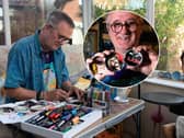 Mark Taylor, a retired art teacher, paints music-themed portraits and album sleeves onto old tin lids and leaves them for gig-goers to take at Waterloo Music Bar.