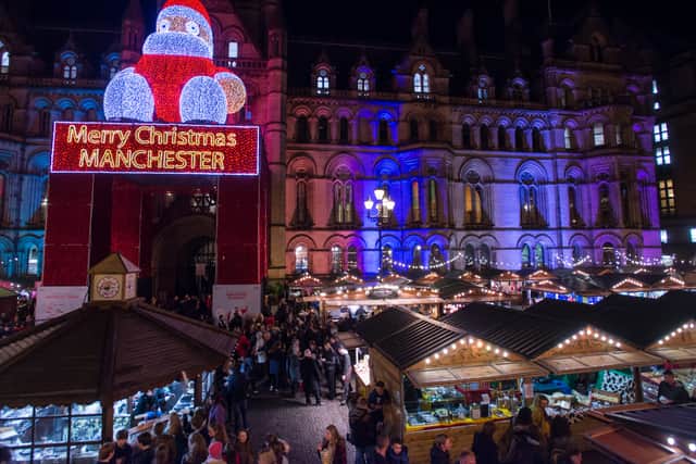 Shoppers enjoy Manchester's Christmas Market with food stalls, bar's, Christmas decorations and various gift stalls outside Manchester Town Hall on December 16, 2015 in Manchester, England.