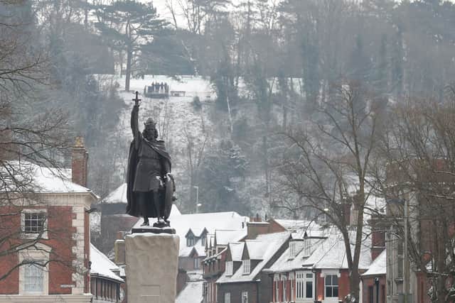 A statue of King Alfred the Great stands tall over the snow covered town of Winchester in south west England on March 2, 2018