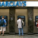 Commuters withdraw cash from ATMs outside a branch of Barclays Bank in London (Photo: Sion Touhig/Getty Images)
