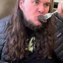 Kalani Smith reviewing a full English breakfast. British cafe goes viral after US TikToker gives glowing reviews of a full English breakfast.