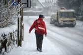 A postman makes his way through the snow.
