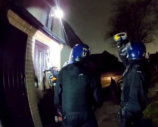 Police used a chainsaw to raid a drug house where they arrested a 13-year-old boy on suspicion of having a zombie knife.