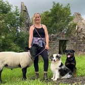 Robyn Swan moved out of her home to live rent-free in a container in rural Scotland, growing her own food and harvesting rainwater. She is pictured with her pet sheep and dogs. Photo: Robyn Swan / SWNS