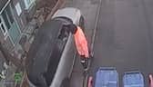 Car drives along pavement to get past bin lorry.