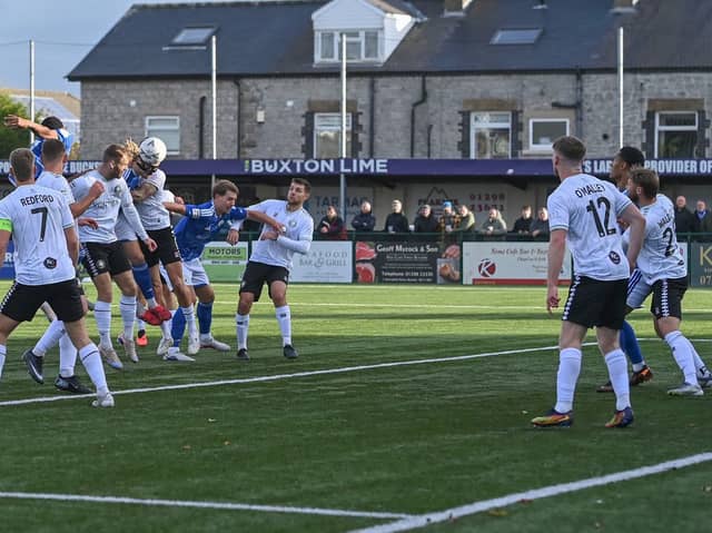 Kieran Burton heads home Buxton's first goal against Worksop Town