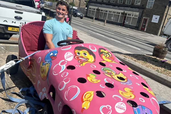 High Peak Comps owner Charles Edwards in Dove Holes, with their soapbox they will ride for charity. 