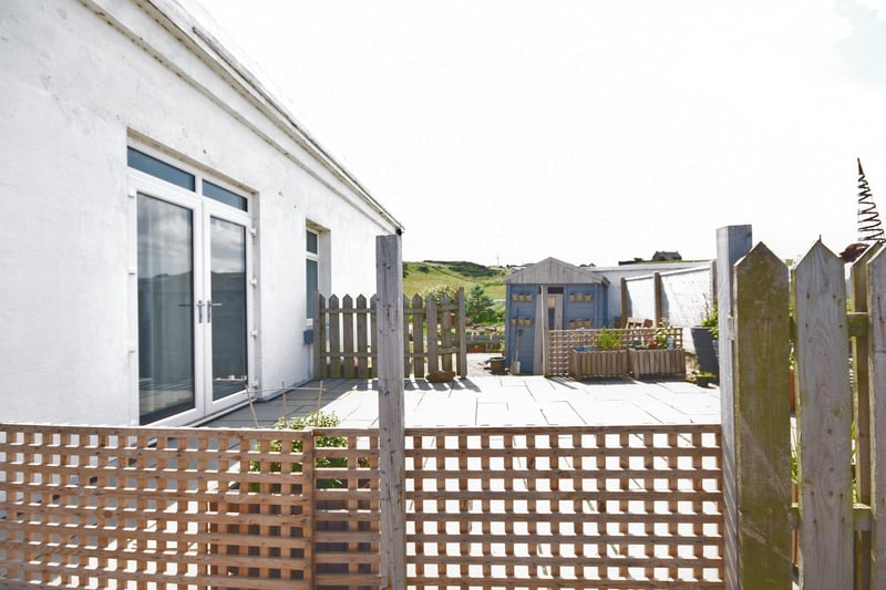 The property has a number of sitting out areas including this decked terrace