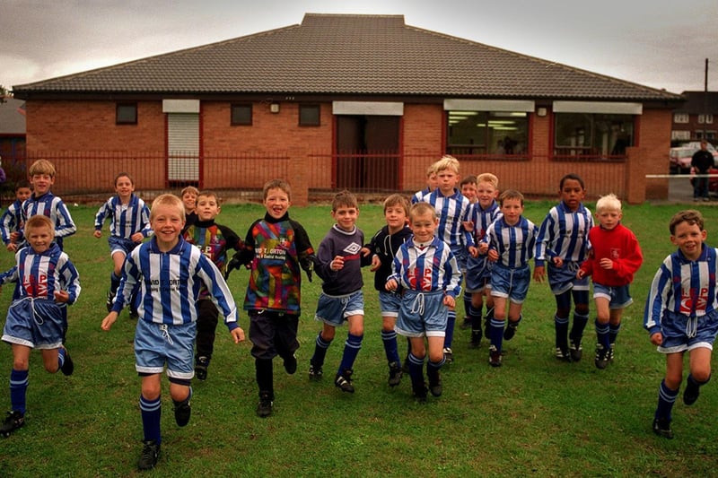 Beeston Juniors run out from their new club house on Cardinal Square.