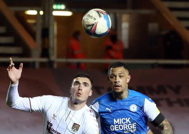 Jonson Clarke-Harris of Peterborough United closes down Lloyd Jones of Northampton Town. Photo: Joe Dent/theposh.com.