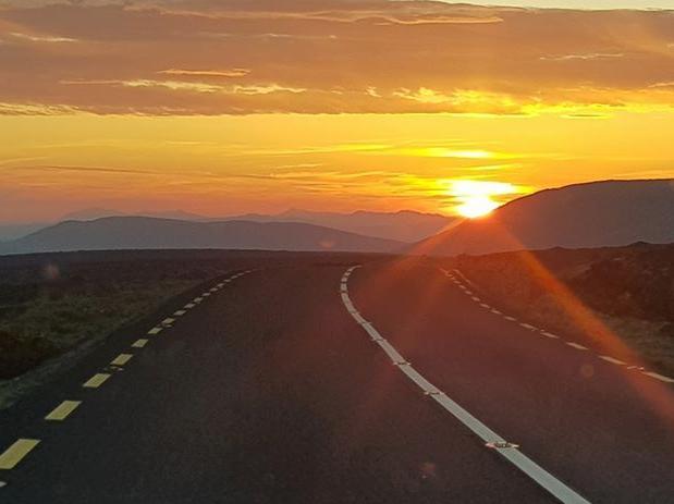 Jerry Sharkey: "Essential worker, driving through the night delivering the news on both sides of the border. Errigal sunrise".