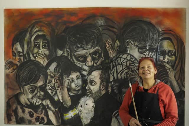 Laura Hyland with her latest piece Remembering Grenfell which will be on display at the Green Man Gallery this weekend.
