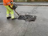 Pictured is a Derbyshire County Council worker repairing one of the many potholes on the county's roads, courtesy Of Derbyshire County Council