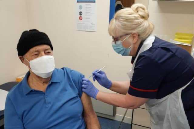 Thornbrook Nurse Trisha Longden gives the first vaccine