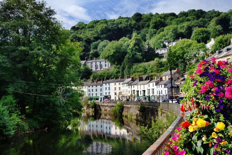 A beautiful view of the River Derwent flowing through Matlock Bath with trees and flowers