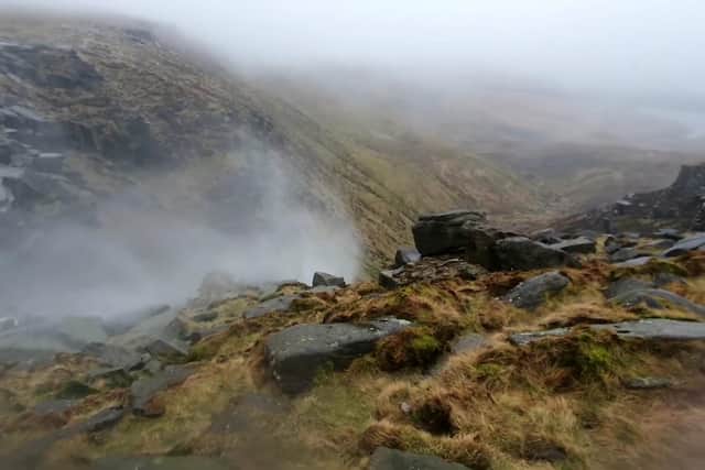 Kinder Scout waterfall flows upwards due to high winds.