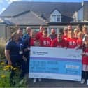 Steve Gregory's family who walked from Buxton to Old Trafford to raise funds for Blythe House in his memory pictured presented the cheque to the charity. Pic submitted