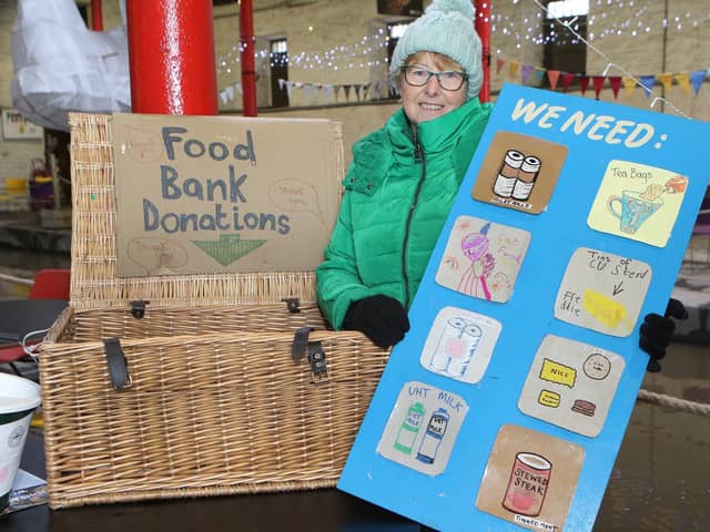 Whaley Bridge Food Bank has a donation point in the warehouse with a board that flags their current requirements. Pictured is volunteer Jan Clay