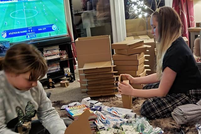 Gemma's daughters, Ruby and Scarlett helping with the packages