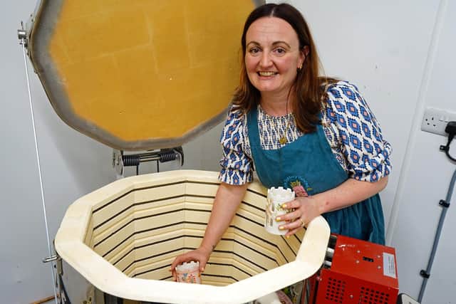 First look at Buxton pottery painting in the Cavendish arcade, Buxton. Leanne Lawler taking fired pots out the kiln. Photo Brian Eyre
